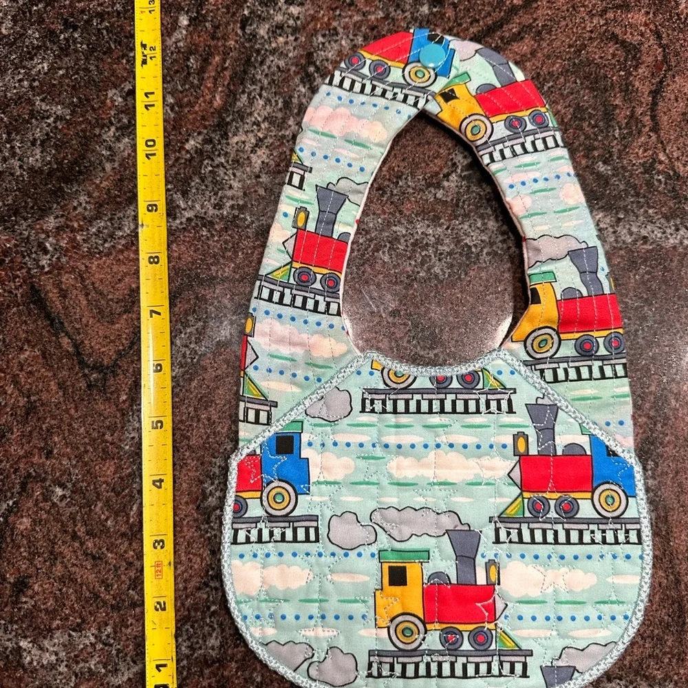 Handmade reversible quilted baby bib with train design